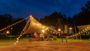 String lights hung across tent for cozy camp vibes