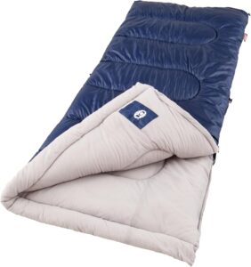 Coleman Brazos sleeping bag unrolled by campfire