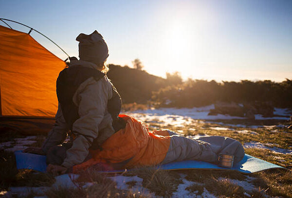 The girl basking in a sleeping bag at dawn.