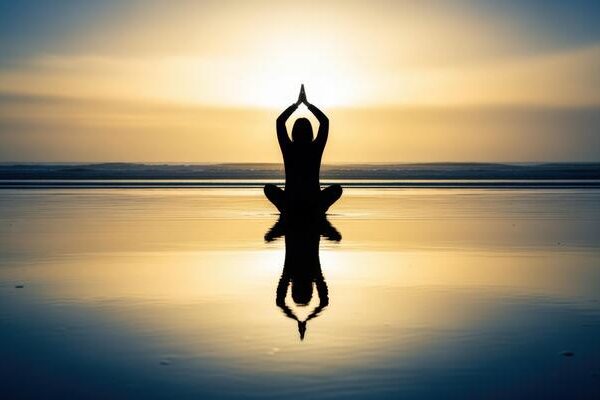 silhouette-of-a-woman-meditating-at-sunset-yoga-spirituality-wellness-and-mindfulness-by-the-water-photo