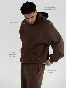Comfrt Minimalist Hoodie and sweatpants set in brown, showing the oversized fit and kangaroo pocket